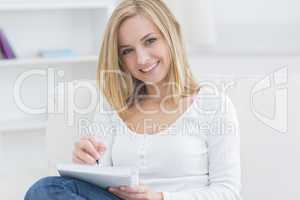 Young woman with notepad and pen at home