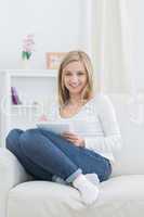 Portrait of relaxed woman with notepad and pen at home