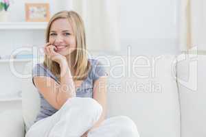 Portrait of relaxed woman sitting on couch