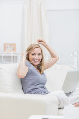 Portrait of excited casual woman with laptop at home Portrait of excited casual woman with laptop at home