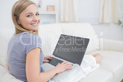 Portrait of casual woman using laptop in living room