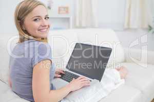 Portrait of casual woman using laptop in living room