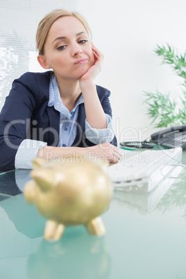 Upset business woman with piggy bank office
