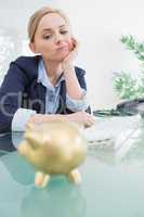 Upset business woman with piggy bank office