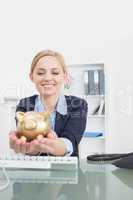 Smiling business woman with piggy bank office