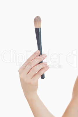 Close-up of hand holding make-up brush