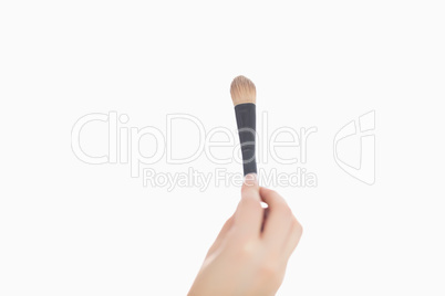 Close-up of hand holding make-up brush