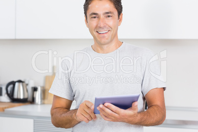 Smiling man using tablet