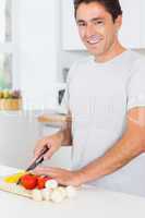 Happy man preparing vegetables