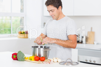 Happy man making dinner