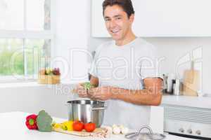 Smiling man making dinner