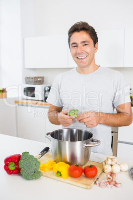 Man putting broccoli in pot