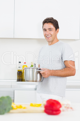 Smiling man carrying pot