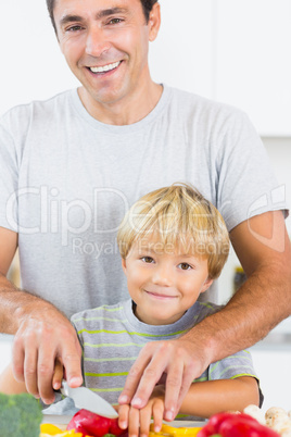 Happy father and son preparing vegetables