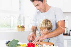 Father and son preparing vegetables together