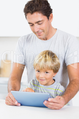 Father and son using tablet