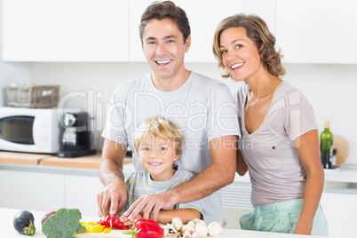 Happy family preparing vegetables