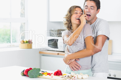 Husband and wife having fun in kitchen