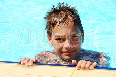 Young smiling boy in pool