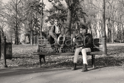 Teenage girl and boy on bench