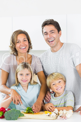 Smiling family preparing vegetables