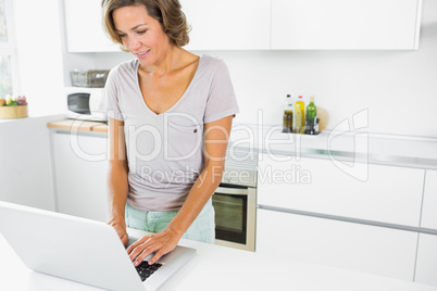 Happy woman using laptop