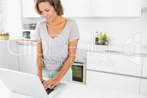 Happy woman using laptop