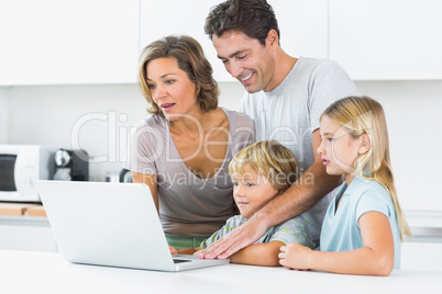 Happy family using laptop