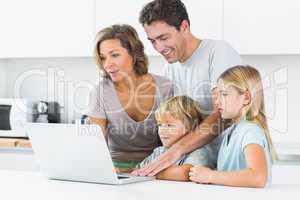 Happy family using laptop