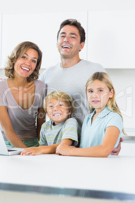 Cheerful family standing in kitchen