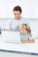 Father and son using laptop