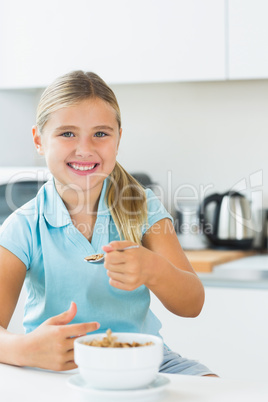 Smiling girl having cereal