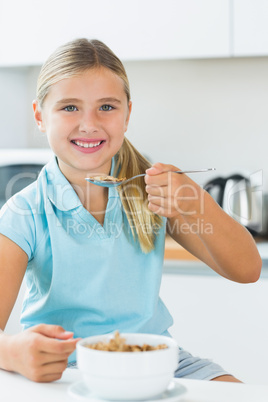 Happy girl eating cereal