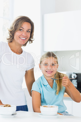 Mother and daughter having cereal