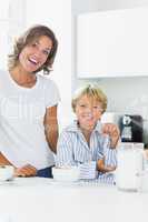 Happy mother and son having cereal