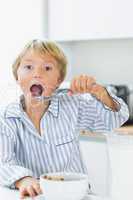 Cute boy having cereal