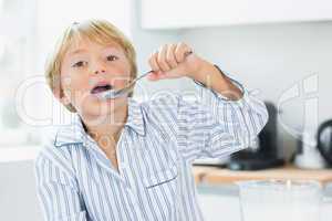 Cute boy eating cereal