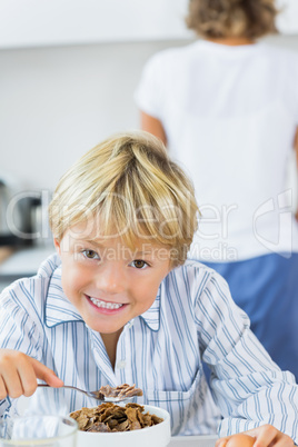 Smiling boy having breakfast