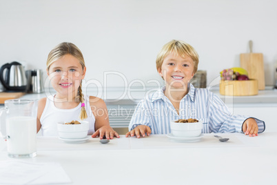 Brother and sister having breakfast