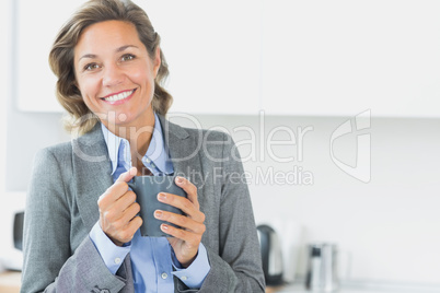 Smiling woman holding coffee mug