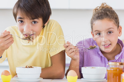 Happy siblings having breakfast