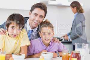 Father and children at breakfast