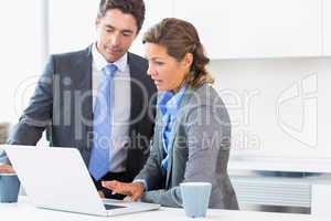 Couple using laptop before work