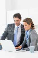 Couple looking at laptop before work