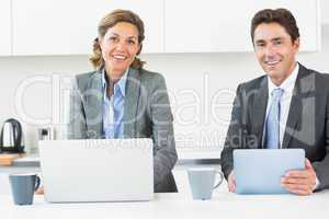 Happy couple with tablet and laptop