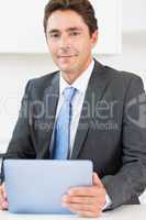 Man in suit using tablet