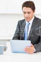 Man using tablet pc before work