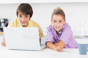 Siblings using laptop