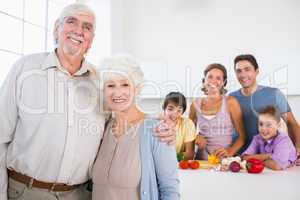 Grandparents standing by kitchen counter
