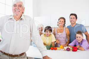 Grandfather standing beside counter in kitchen